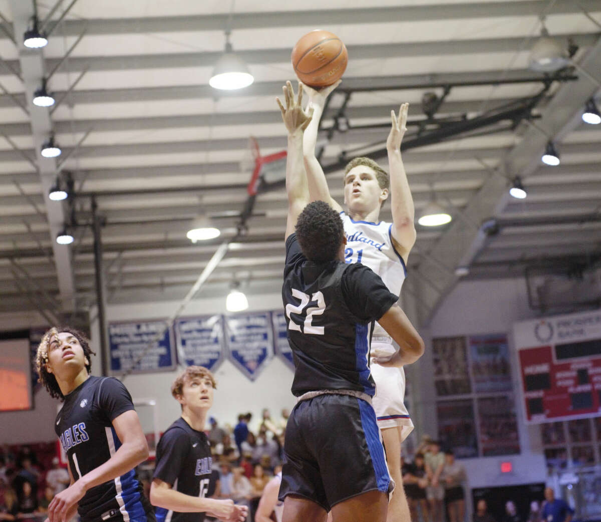 Midland Christian's Josiah Wray makes a turnaround shot over Fort Worth Southwest Christian's Jacoby August during a TAPPS 1-5A boys basketball game, Jan. 10 at McGraw Event Center. 