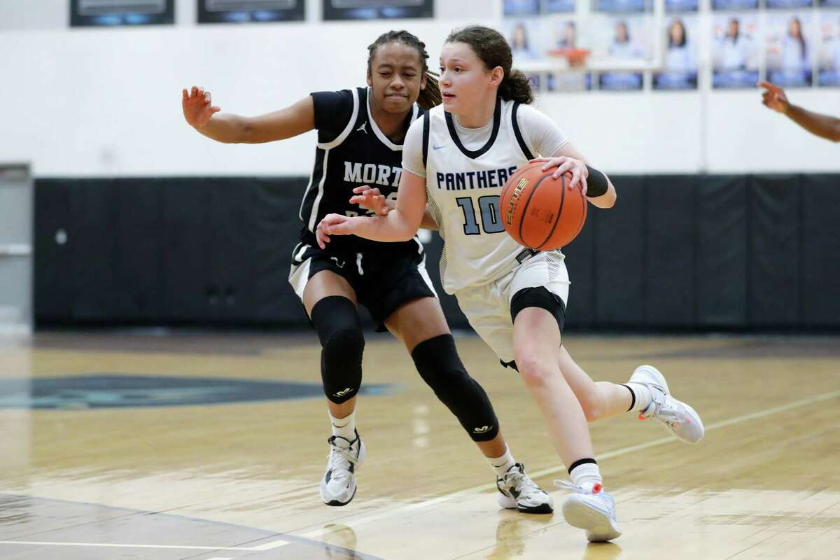 Paetow’s Ellie Lee, right, drives past Morton Ranch’s Trinitee McFarland, left, during their District 19-6A basketball game held at Paetow High School Tuesday, Jan. 10, 2023 in Katy, TX.