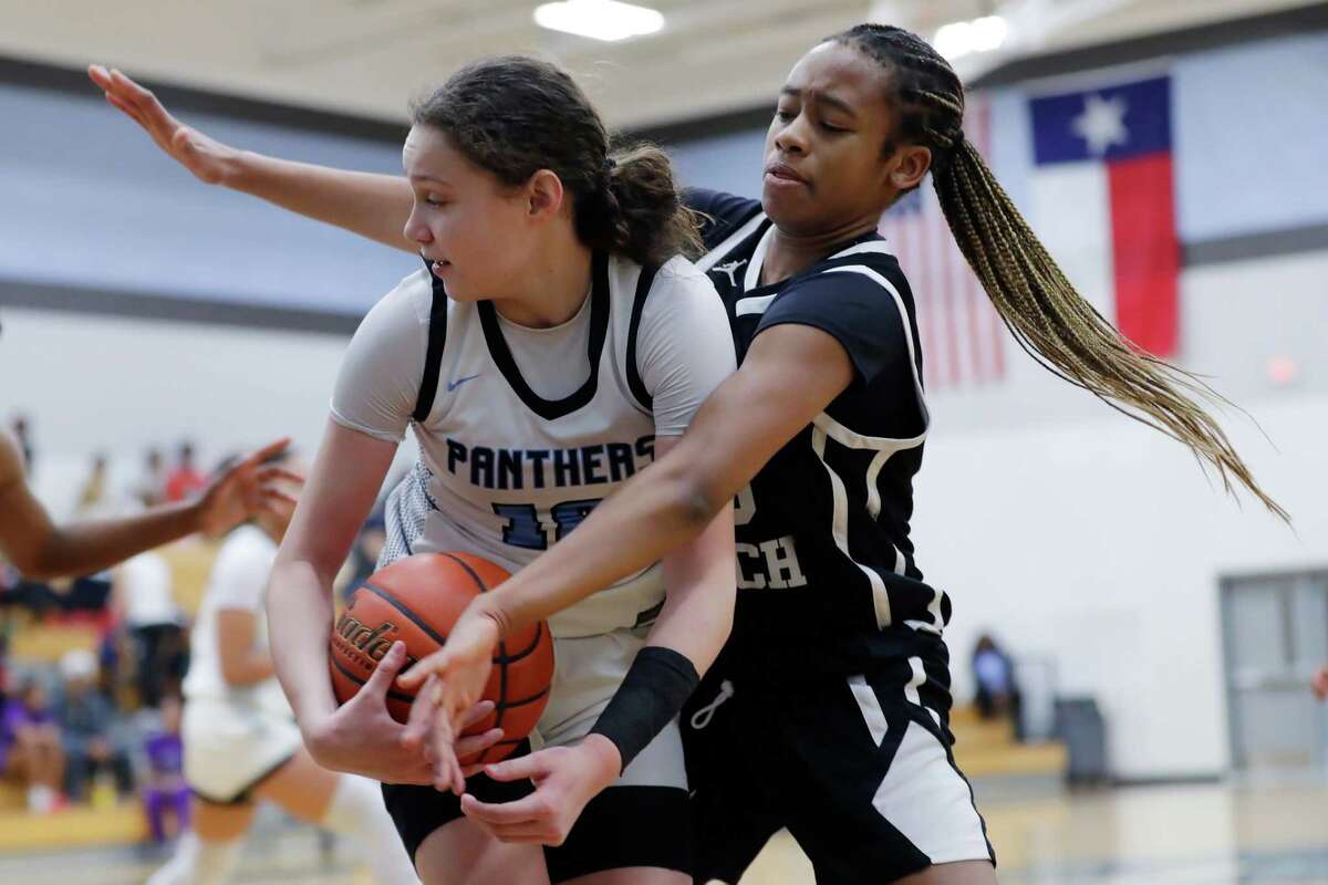 Paetow’s Ellie Lee, left, looks to pass the ball as Morton Ranch’s Trinitee McFarland, right, boxes her in during their District 19-6A basketball game held at Paetow High School Tuesday, Jan. 10, 2023 in Katy, TX.