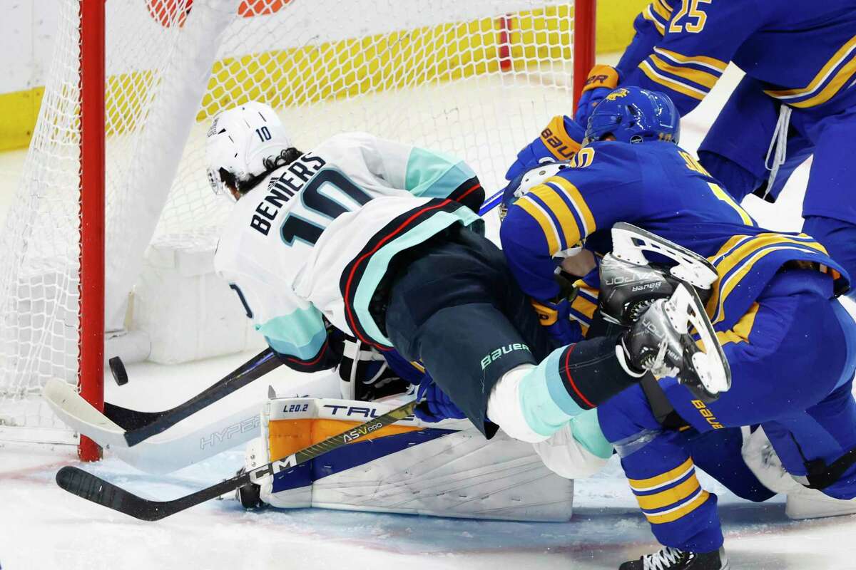 Seattle Kraken center Matty Beniers (10) puts the puck past Buffalo Sabres goaltender Eric Comrie (31) during the third period of an NHL hockey game, Tuesday, Jan. 10, 2023, in Buffalo, N.Y. (AP Photo/Jeffrey T. Barnes)