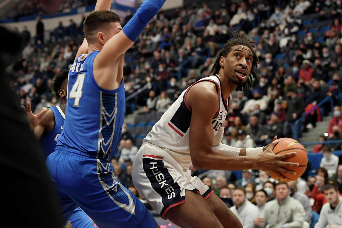 Connecticut's Isaiah Whaley looks to shoot as Creighton's Ryan Hawkins, left, defends in the first half of an NCAA college basketball game, Tuesday, Feb. 1, 2022, in Hartford, Conn. (AP Photo/Jessica Hill)