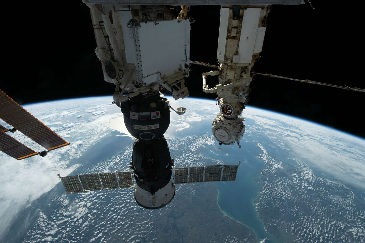 The Soyuz MS-22 crew ship is shown as the International Space Station orbited 264 miles above Europe. This spacecraft was struck by a micrometeoroid and will not carry crew home.