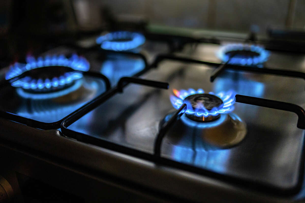 Flames are lit atop a gas stove. 