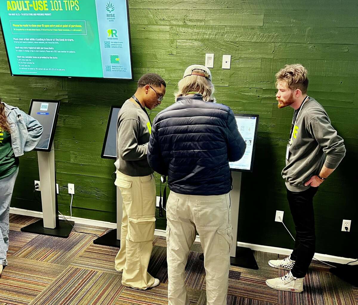 Budtenders help a customer on the first day of retail cannabis sales at RISE in  Branford  on Jan. 10, 2023.