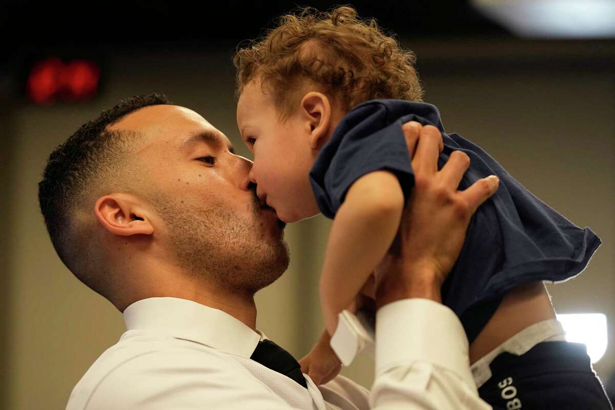Minnesota Twins baseball player Carlos Correa kisses his son Kylo, 1, following a press conference at Target Field Wednesday, Jan. 11, 2023, in Minneapolis. The team and Correa agreed to a six-year, $200 million contract.