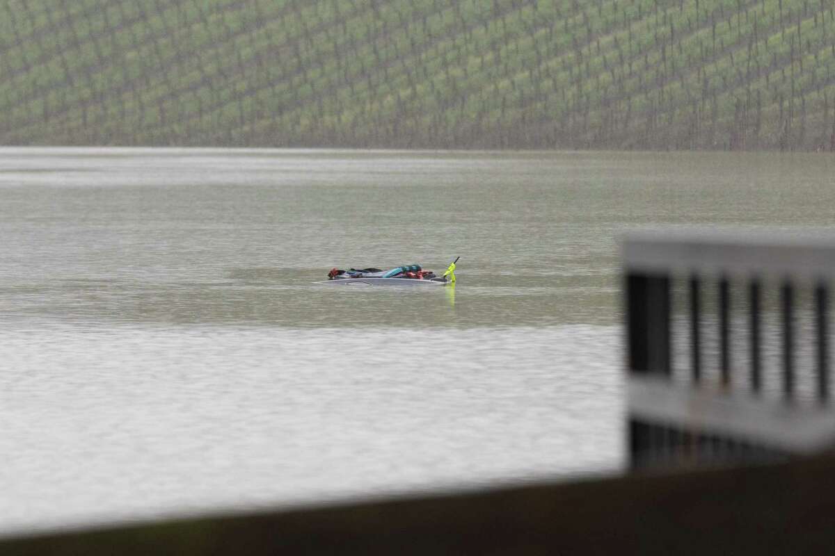 The top of a car is marked with floatation devices in the flooded area of a vineyard along the 6000 block of Trenton-Healdsburg Road in Forestville Calif., on Wednesday, Jan. 11, 2023. Sonoma Sheriff’s Twitter account announced they had recovered the body of a 43-year-old individual from a submerged car in the area.