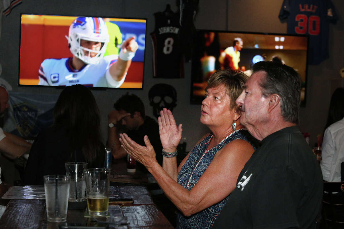 Carrie and Michael Lee from San Luis Obispo watch Buffalo Bills quarterback Josh Allen take on the Kansas City Chiefs, at the PressBox Sports Grill in Fresno, on Sunday, Oct. 16, 2022. 