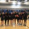 Janay Brantley, center with ball, poses with her team after reaching 2,000 career points.
