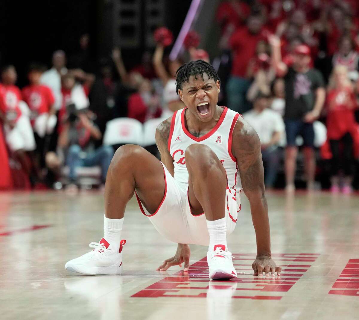 Houston Cougars guard Marcus Sasser (0) screams after he was fouled by South Florida Bulls guard Jamir Chaplin as he shot a three-pointer during the second half of a NCAA mens basketball game at the Fertitta Center on Wednesday, Jan. 11, 2023 in Houston. UH beat the South Florida Bulls 83-77.