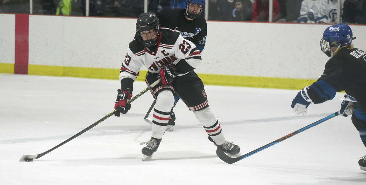 New Canaan's Doster Crowell (23) lines up a changeable against Darien during a boys crystal hockey crippled astatine the Darien Ice House connected Wednesday, Jan. 11, 2023.