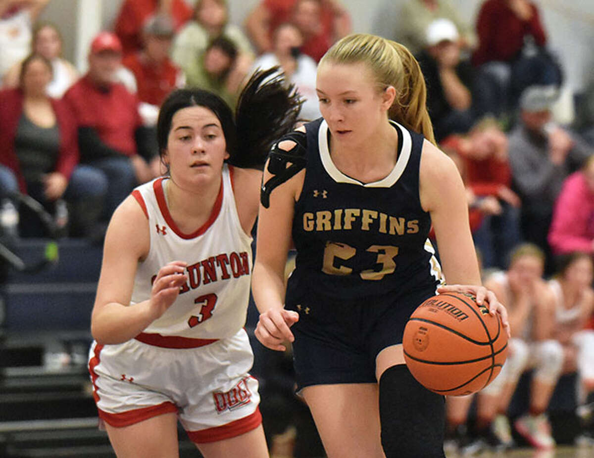 Father McGivney's Sami Oller (right) drives around Staunton's Lilly Troeckler on in the championship game of the Christ Our Rock Winterfest in Centralia on Dec 30. The Griffins make their debut in the Class 1A state poll this week at No. 10.