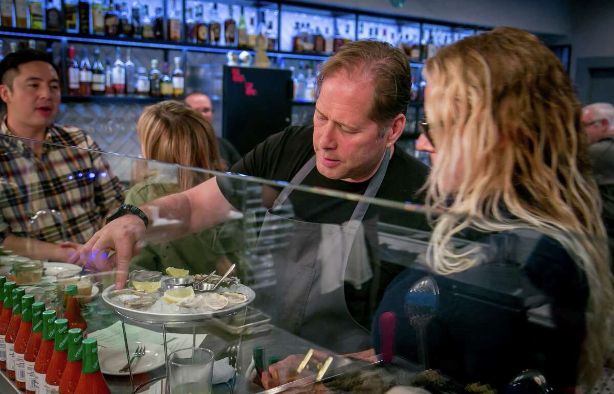 Chef David Kinch shows Judith Manning which oysters are which at the Bywater in Los Gatos in 2016. After closing Manresa at the end of 2022, he announced plans to open three new projects in Los Gatos.