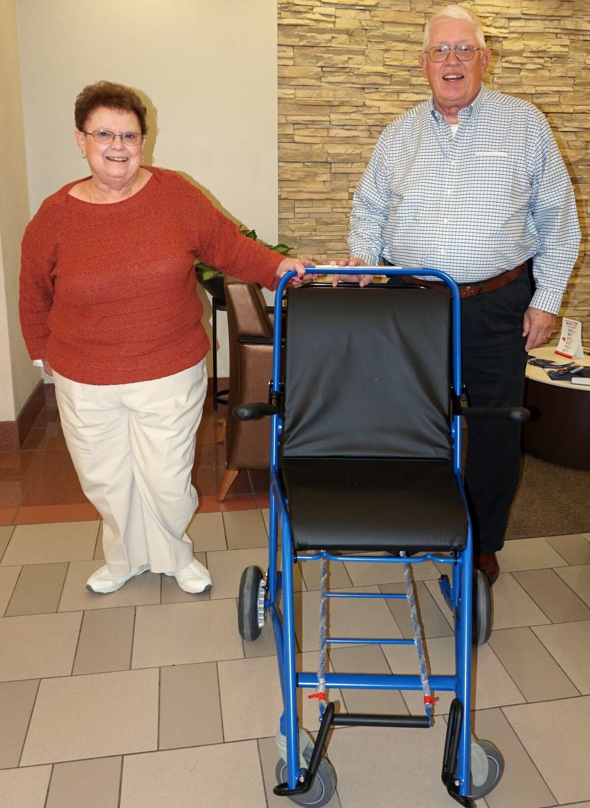 Rose and Fred Lammers are shown with the wheelchair they recently purchased for Alton Memorial Hospital.