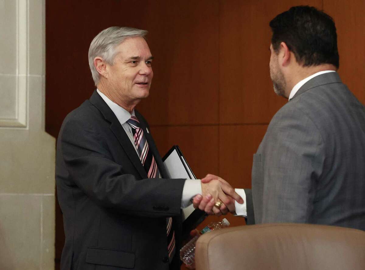 Embroiled District 10 Councilman Clayton Perry (left) shakes hands with City Manager Erik Walsh as he makes his first appearance at City Council on Thursday, about two months after he took leave following a drunken driving charge in November. In an earlier press statement, Perry stated, “I want to assure everyone that I kept the commitment I made at the last meeting to follow all the appropriate measures as recommended by medical experts and will continue to do so, I'm not done and again ask for everyone's compassion and forgiveness.”
