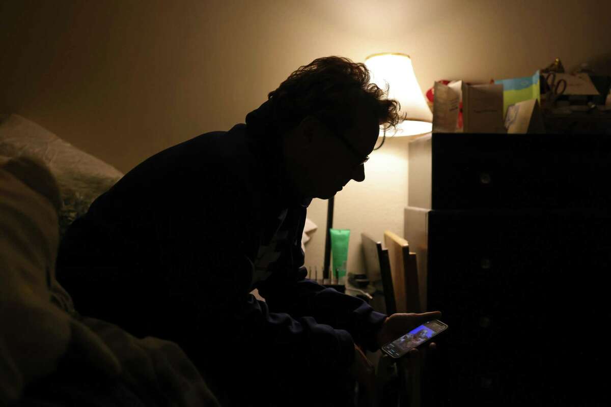 Marc Fontino looks at photos of his wife Daphne on his phone in his townhome in Ukiah. Daphne Fontino, 43, became the latest of at least 18 people who have died during a series of powerful California storms.