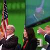 Plug Power CEO Andy Marsh, left, and Gov. Kathy Hochul cheer as U.S. Senate Majority Leader Charles Schumer, reflected right, delivers a speech during a ribbon cutting for Plug Power's new manufacturing facility on Thursday, Jan. 12, 2023, in Slingerlands, N.Y.