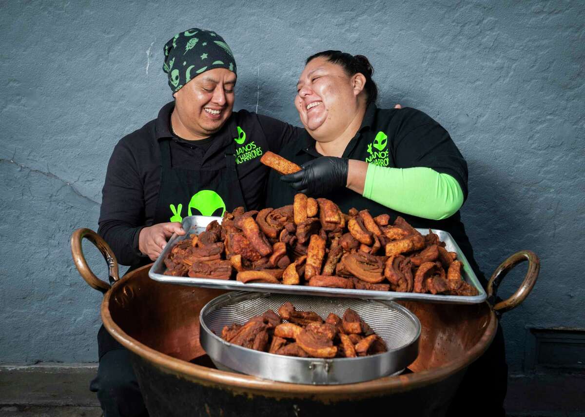 The owners of Nano's Chicharrones, Juan "Nano" Ballona and Elizabeth Ballona, with a freshly made batch of chicharrones at their home restaurant.
