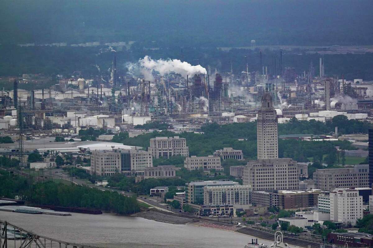 The Exxon Mobil Baton Rouge Refinery complex is visible with the Louisiana State Capitol, bottom right, in Baton Rouge, La., Monday, April 11, 2022. Exxon Mobil’s scientists were remarkably accurate in their predictions about global warming, even as the company made public statements that contradicted its own scientists' conclusions, a new study says.