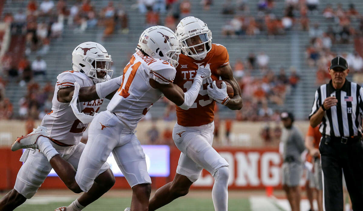 AUSTIN, TEXAS - APRIL 23: Ishmael Ibraheem #19 of Texas Longhorns is forced out of bounds by Jamier Johnson #31 during the Orange-White Spring Game at Darrell K Royal-Texas Memorial Stadium on April 23, 2022 in Austin, Texas. (Photo by Tim Warner/Getty Images)