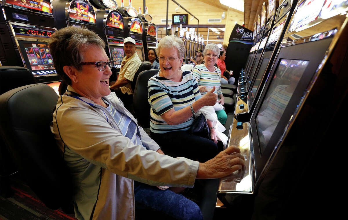 Trinity, Texas resident Shirley Sheffield (center) reacts as Patti Rau (left) wins on a gaming machine as their friend Jan Pistole watches on at Naskila Entertainment in Livingston, Texas on Tuesday, June 7, 2016.The Alabama Coushatta Indian Tribe in Livingston - about an hour north of Houston - reopened its casino after a 14-year closure prompted by threats from the state of Texas to take legal action against the tribe. Recent legal developments paved the way for the reopening. With 365 Class 2 electronic gaming devices, the former casino has been renamed Naskila Entertainment and its doors opened earlier this month to eager guests and gamers. Only "bingo" type machines are in use at Naskila Entertainment according to officials. (Kin Man Hui/San Antonio Express-News)