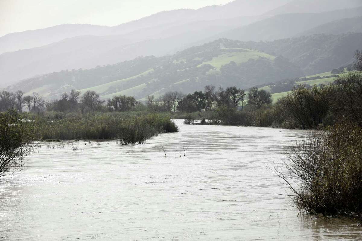 A flooded Salinas River can be seen from the bridge on Chualar River Road in Salinas in Monterey County, Calif. on Thursday, Jan. 12, 2023.