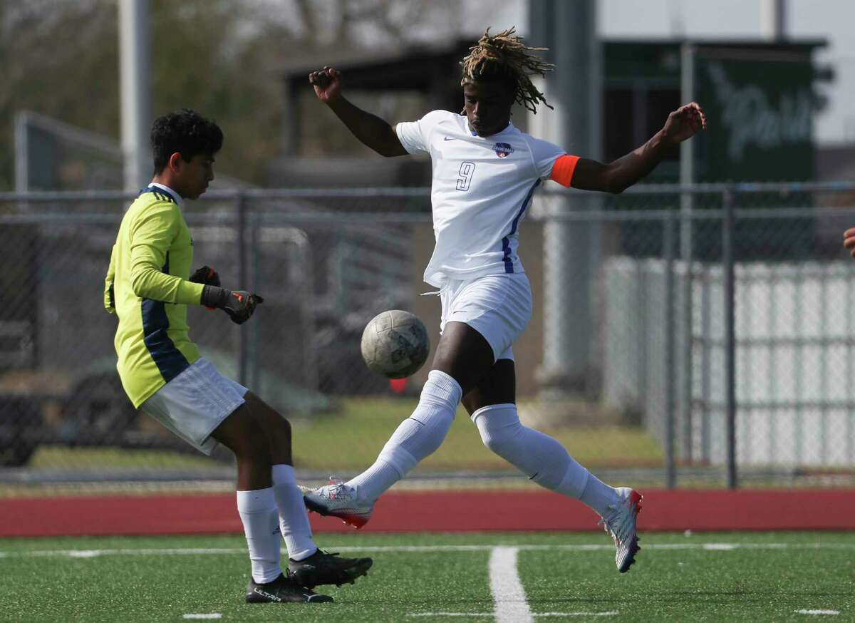 Grand Oaks’ Ramiere Johnson (9) has his shot broken up by Cypress Lakes goalie Andy Garcia (1) in a high school soccer match during the Humble ISD Classic at Kingwood Park High School, Thursday, Jan. 11, 2023, in Kingwood.