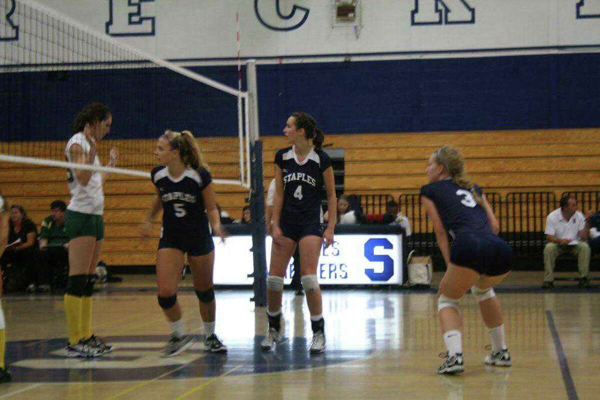 Staples senior captain Lucy Stanley, No. 4, and juniors Anna Link, No. 5 and Augie Gradoux-Matt, No. 3, await a serve last Wednesday against Trinity Catholic. All three contributed to the Lady Wreckers' 3-2 home victory over Stamford on Friday.