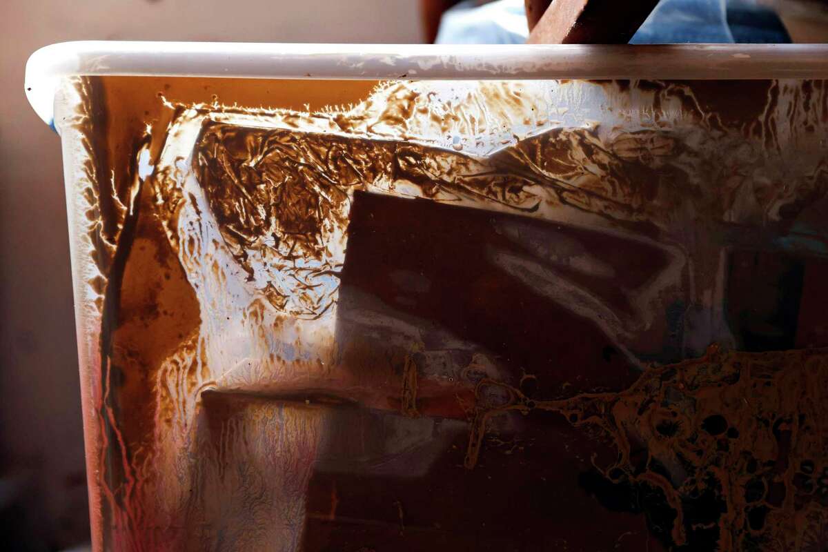 A box containing craft projects made by photographer Jessica Christian as a child sits in a mixture of water and mud after her mother's storage space was flooded at her home during a major storm in Sunol, Calif. Wednesday, Jan. 11, 2023
