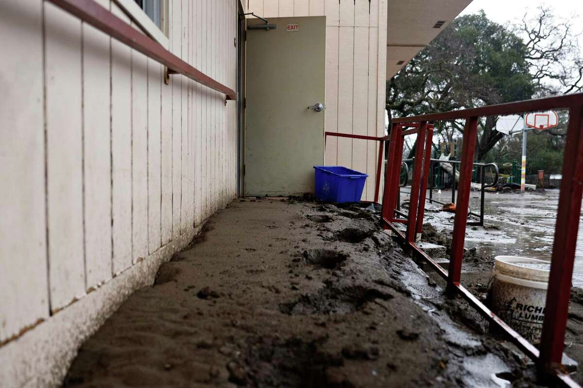 Thick mud lines the walkway of a portable classroom at Sunol, Calif. Thursday, Jan. 5, 2023 after heavy rains caused mudslides, flooding and other hazardous conditions across the already devastated town.