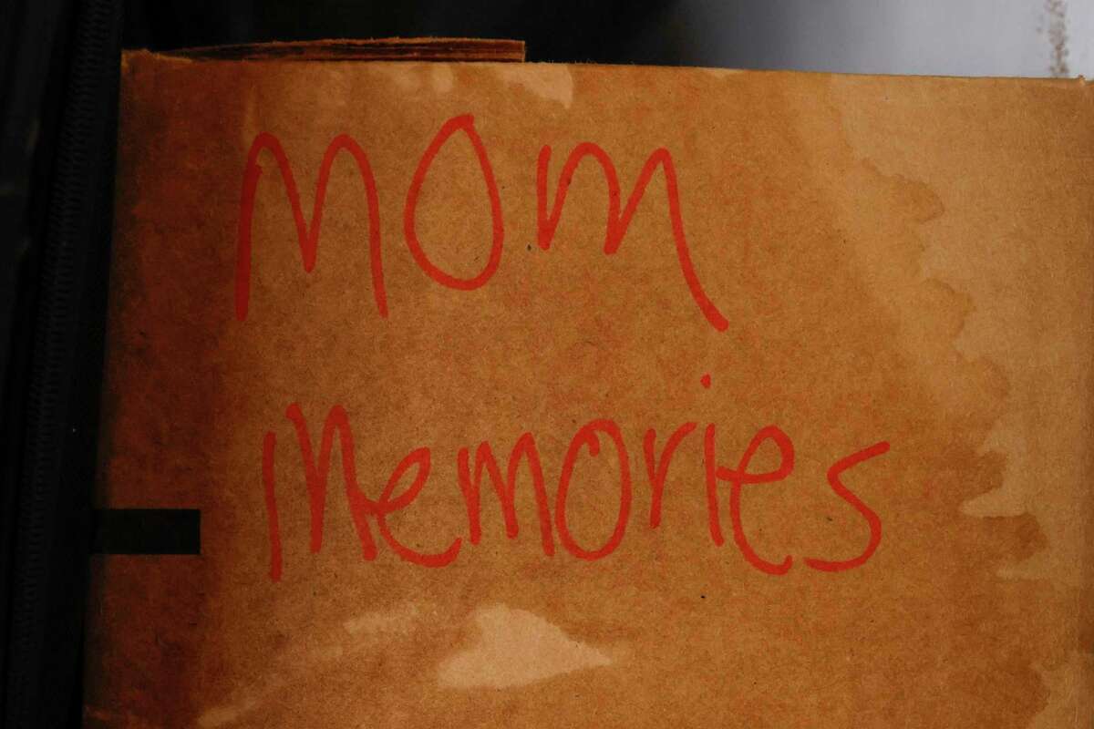 A box of memories from my grandmother’s life that my mom saved is seen waterlogged by floodwaters in her garage storage space.