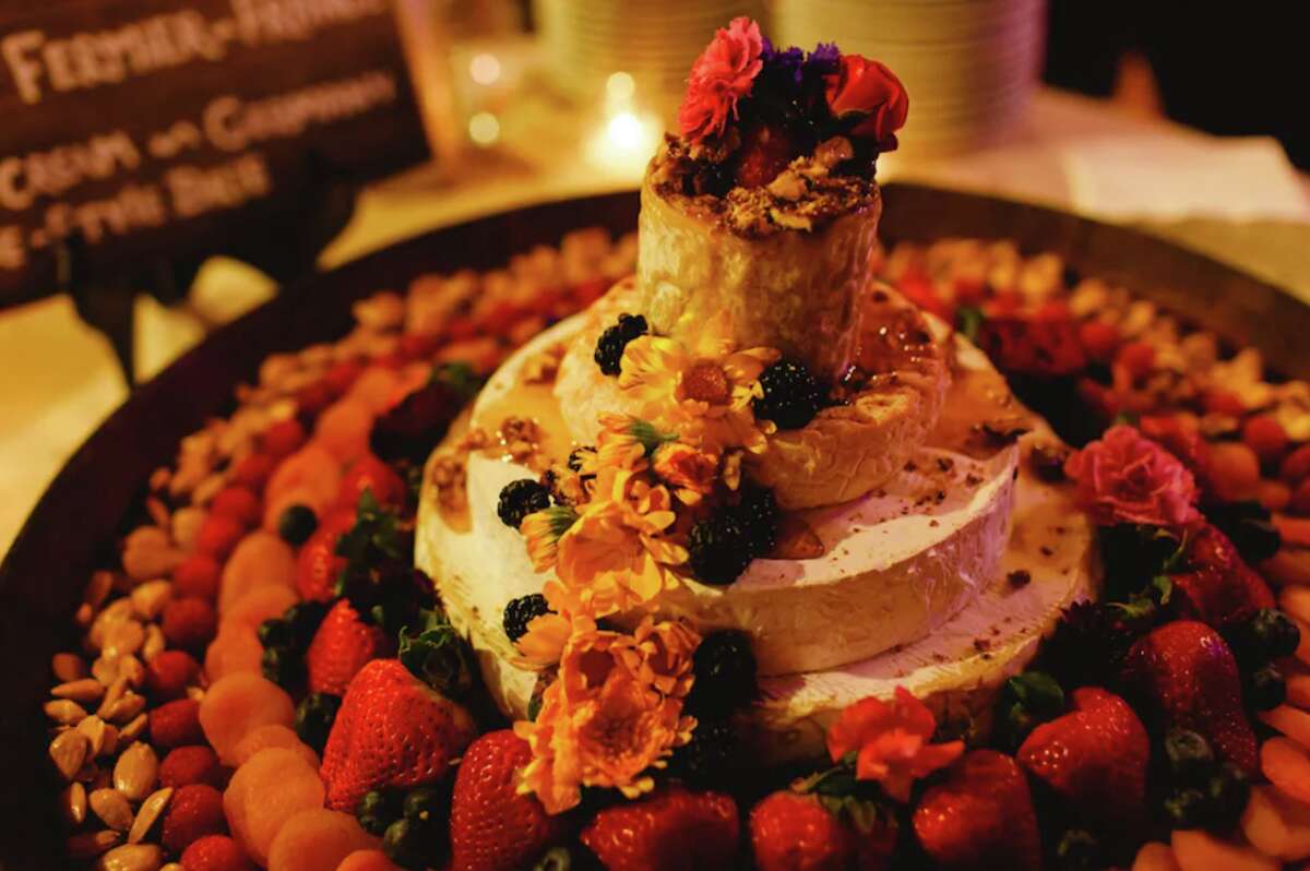 Chronicle reporter Jess Lander's cheese tower wedding cake, decorated with fruit, nuts, flowers and honey. 