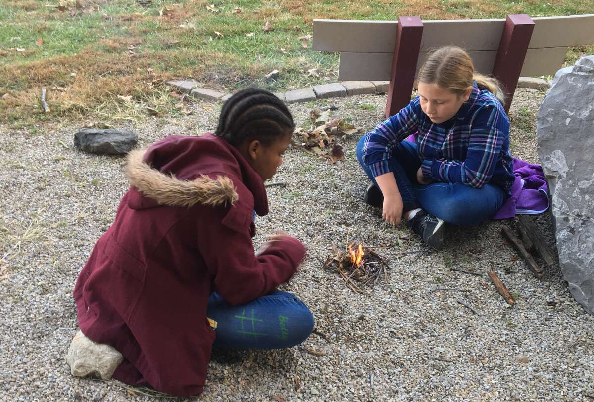Children learn how to start an impromptu camp fire at a past event at The Nature Institute (TNI) in Godfrey. TNI will present an upcoming event, “Family Discovery Day: Winter Survival Challenge,” at 10 a.m. Saturday, Jan. 21, to learn, explore, and put to test ability to survive the cold.