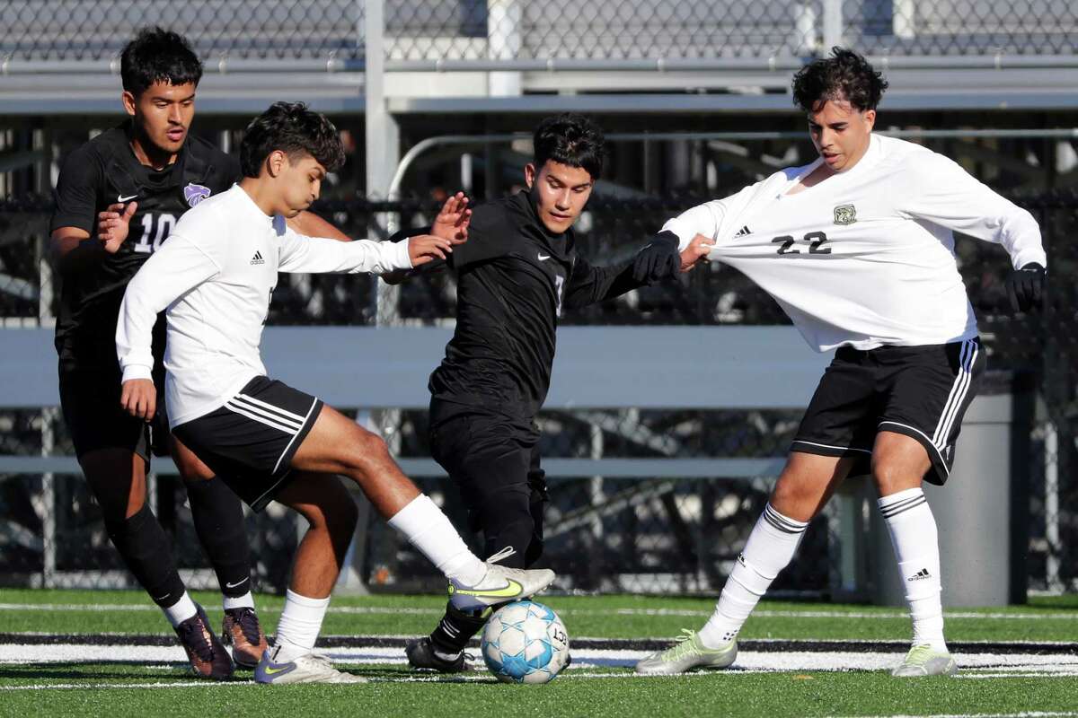 Humble’s Alejandro Tobar, center, pulls on Cypress Park’s Adam Chaouch (22) as he battles for the ball with Irvin Martinez, left, as Aaron Rodriguez (10) looks on during their non-district soccer game held at Charles Street Stadium Thursday, Jan. 12, 2023 in Humble, TX.