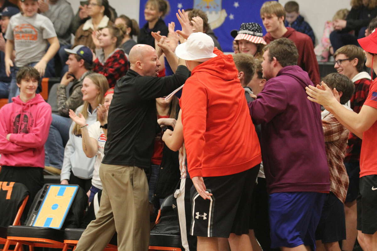 Harbor Beach coach Jim Tamlyn celebrates victory with the student section.