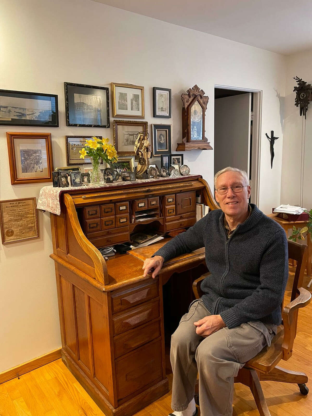 Tom Erickson sits at the roll top desk that was gifted to his great-grandfather Mike Ryan, who was sheriff in Midland County in the late 1800s. 