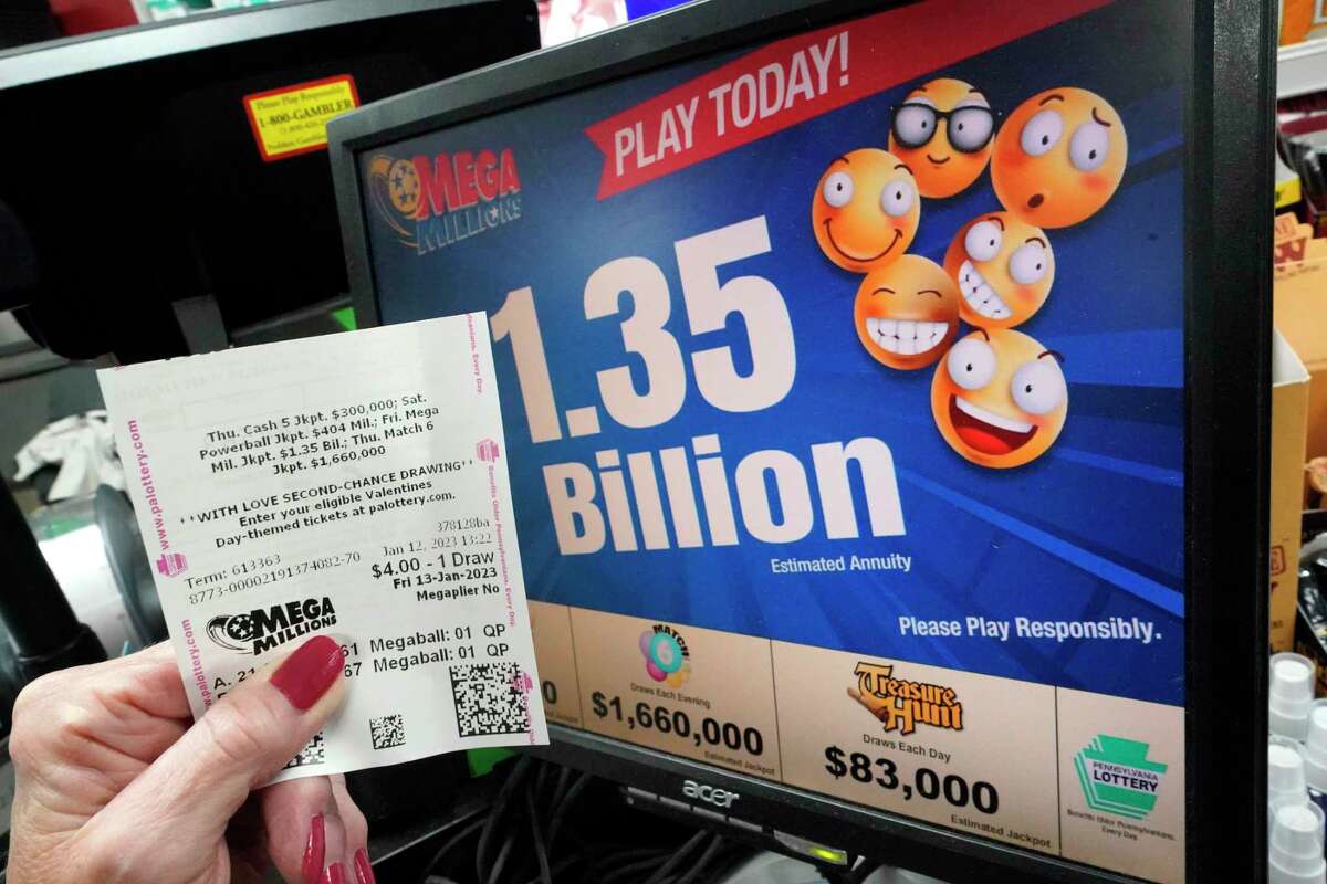 A customer at the Cranberry Super Mini Mart in Cranberry, Pa., shows her Mega Millions ticket on Thursday, Jan. 12, 2023.