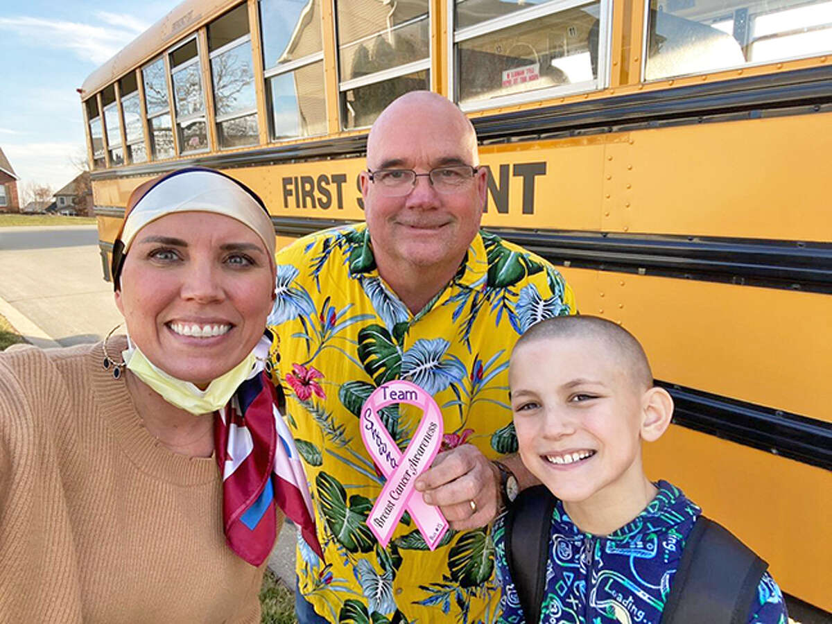 First Student bus driver Kent Fant, middle, with Shawna McMichael, left and her son, Cooper  McMichael, 9, a fourth-grader grader at Cassens Elementary School in Edwardsville. Fant shaved his head to support Cooper, who shaved his head after Shawna shaved her head after losing her hair due to chemotherapy while being treated for breast cancer.