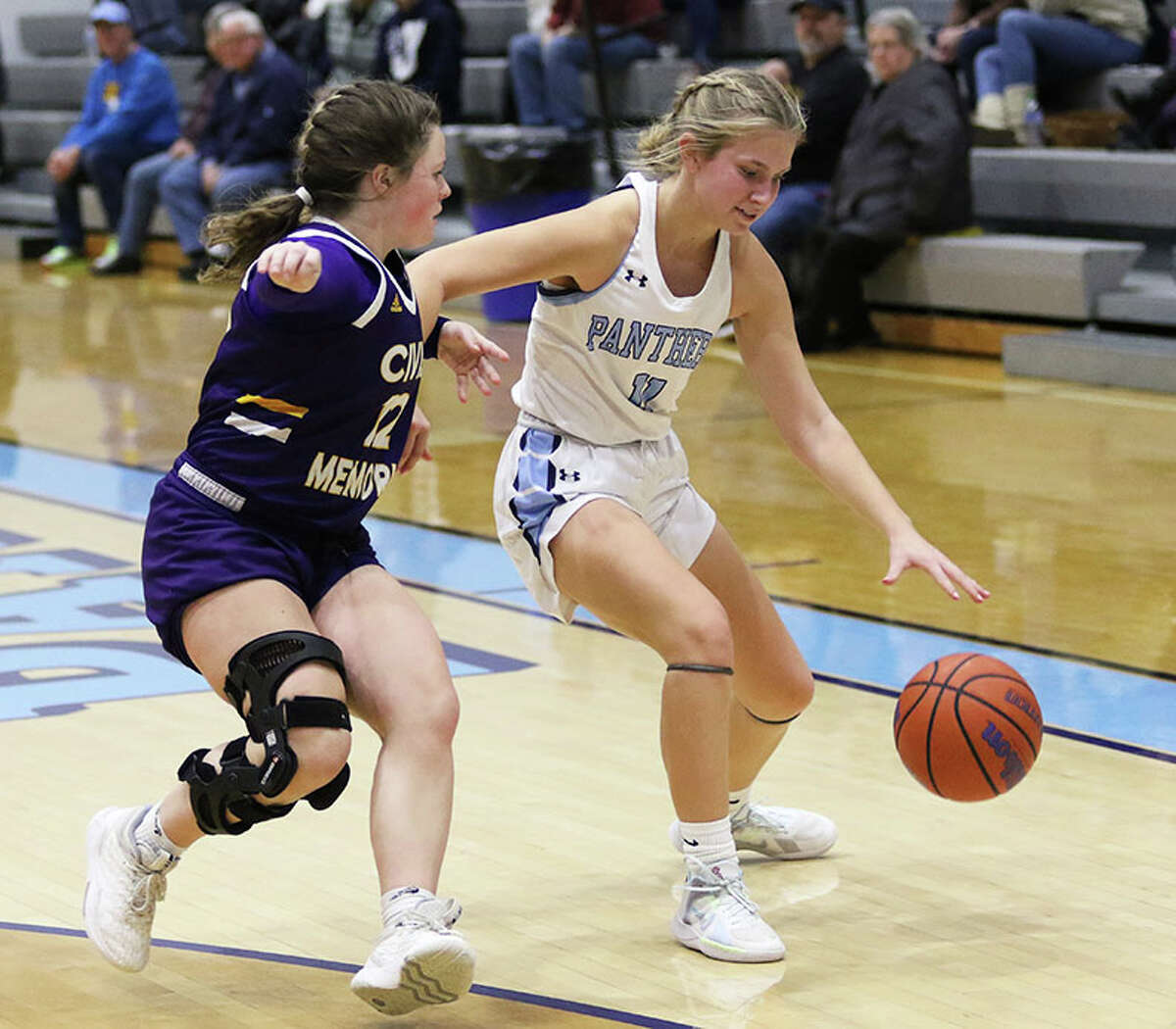 Jersey's Cali Breden (right) handles the ball against defensive pressure from CM's Aubree Wallace on Thursday night in a MVC girls basketball game at Havens Gym in Jerseyville.