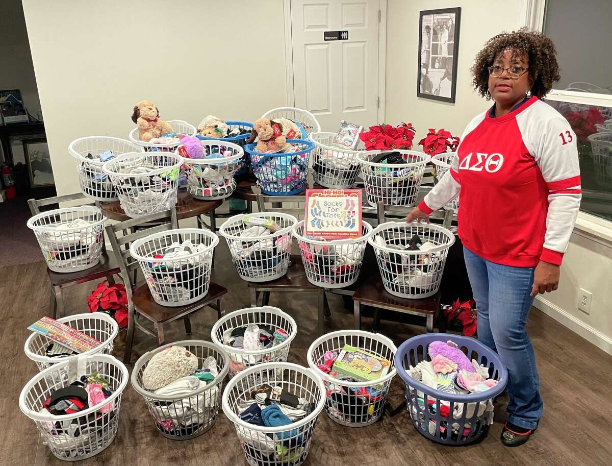 Rosetta "Rosie" Brown of Alton displays donations for the 2022 Socks for Tots drive.