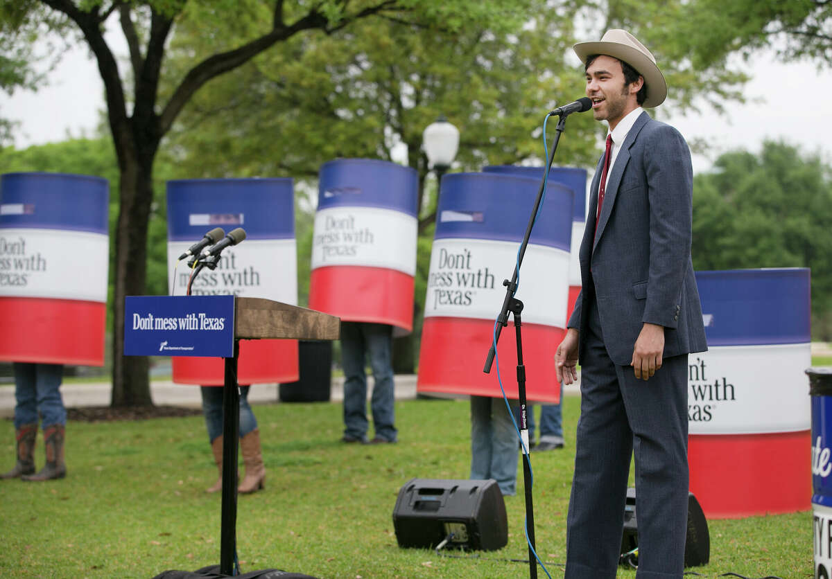 Musician Shakey Graves performs the "Don't Mess with Texas" song with dancing trashcans during a press conference at the Capitol in Austin, Tx., on Tuesday, April 02, 2013. 