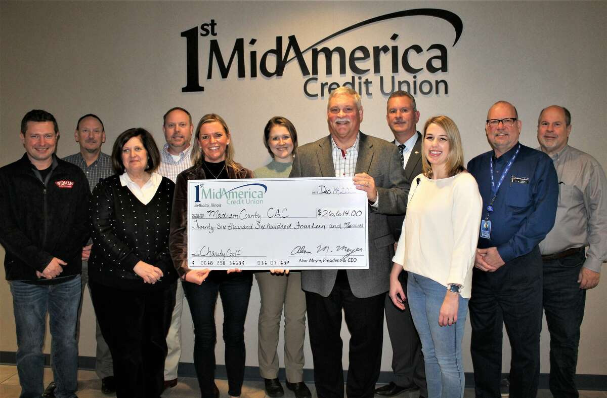 The Madison County Child Advocacy Center received a check for $26,614 from 1st MindAmerica Credit Union’s annual charity golf outing. Pictured are Travis Widman, left, CAC Board Member; Jeff Whitaker, VP of Commercial Services and CAC Advisory Board Member; Elysa Robin, VP of Human Resources and CAC Friends Board Member; James Cherry, SVP of Information Technology and CIO; Carrie Cohan, Executive Director for the CAC; Caroline Livingstone, Fund Development Specialist for the CAC; Alan Meyer, President and CEO; Sheriff Jeff Connor, CAC Board Member; Olivia Turner, Marketing Manager, and CAC Friends Board Vice President; Perry Withers, SVP of Lending and CLO; Bob Blacklock, SVP of Finance and CFO.  