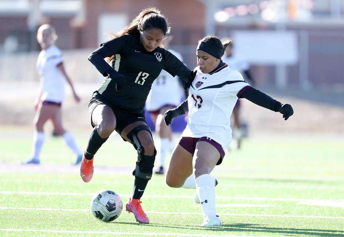 Conroe's Bianca Castaneda (13) and Magnolia West's Taea Jemison (13) battle for the ball during a high school soccer match at the Kat Cup soccer tournament at Willis High School, Friday, Jan. 13, 2023, in Willis.