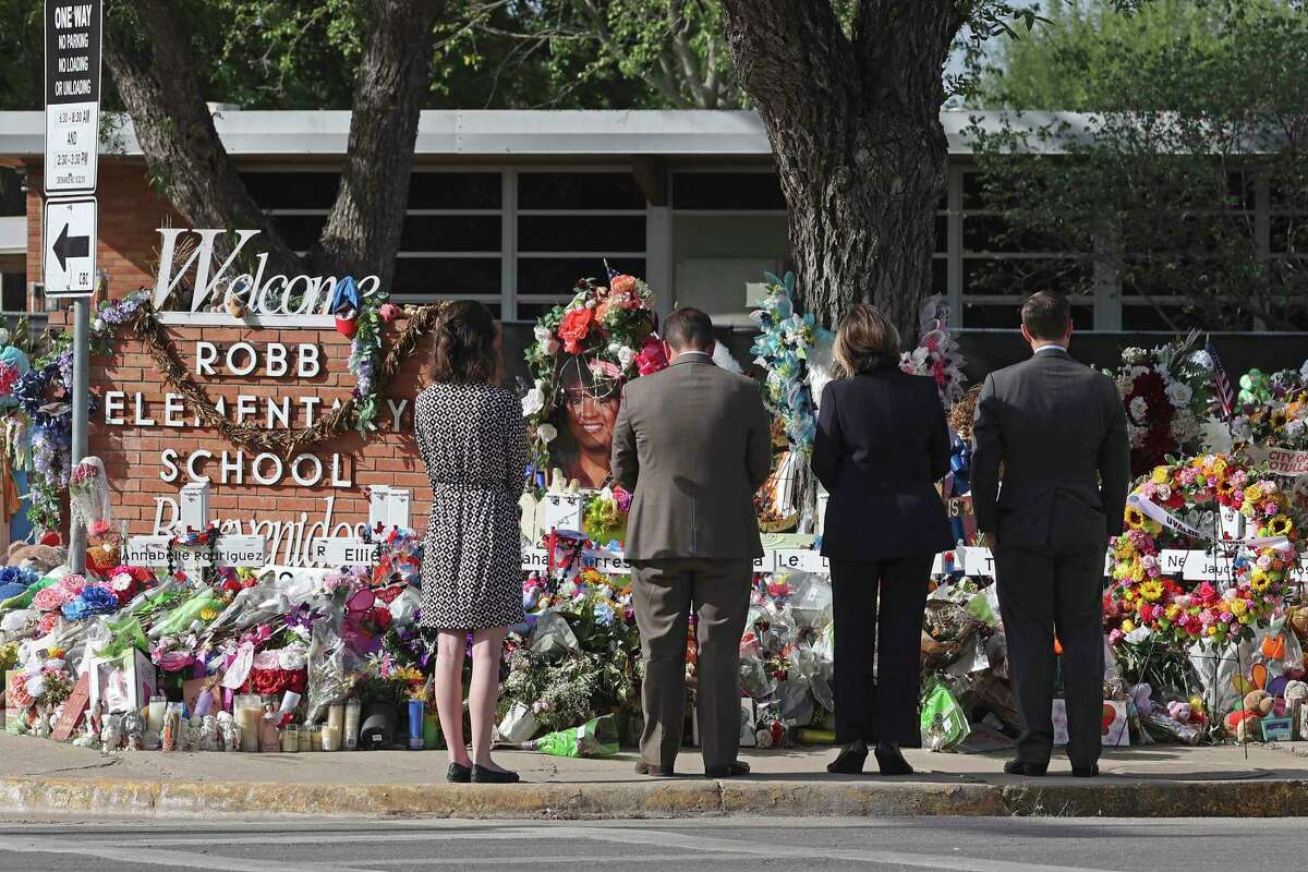 Members of the special Texas House panel investigating the May 24 shooting take a moment after placing a wreath at the memorial at Robb Elementary School in Uvalde on June 17. From left are committee clerk Paige Higerd, Rep. Joe Moody, D-El Paso, former Texas Supreme Court Justice Eva Guzman and Rep. Dustin Burrows, R-Lubbock.