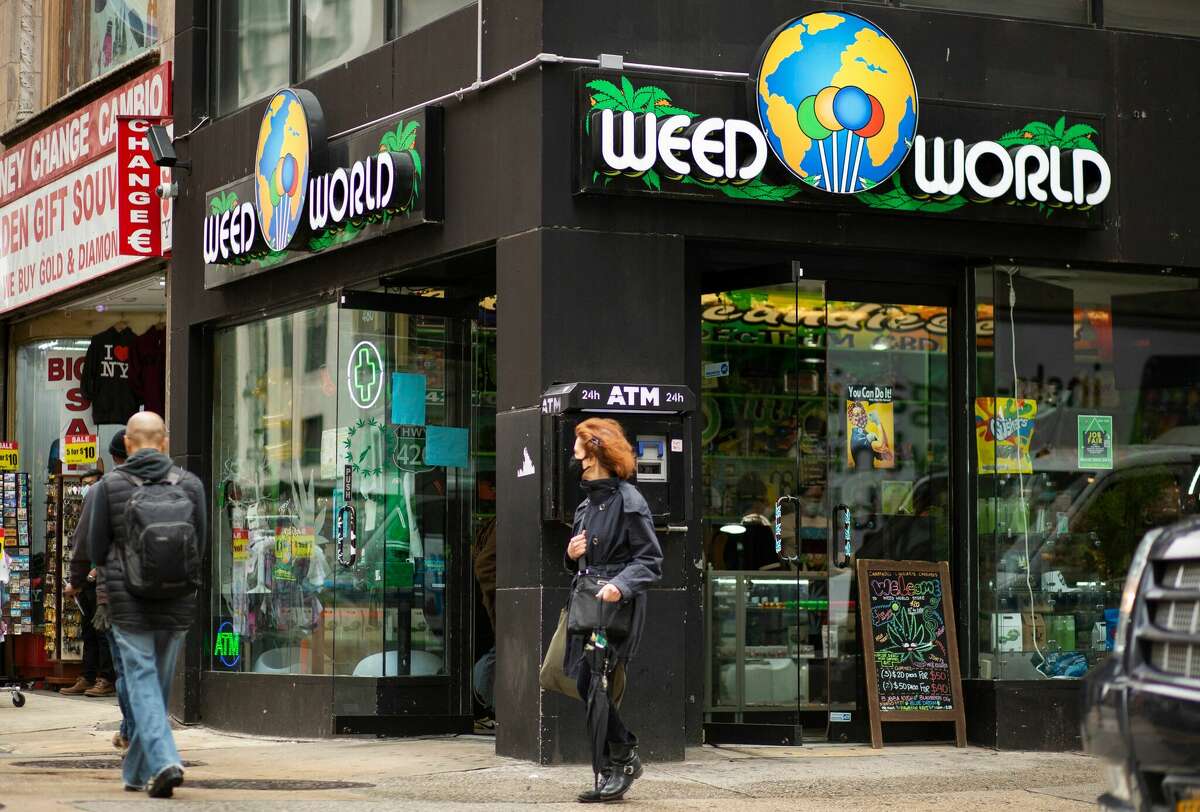 People walk past the Weed World store in Midtown Manhattan.