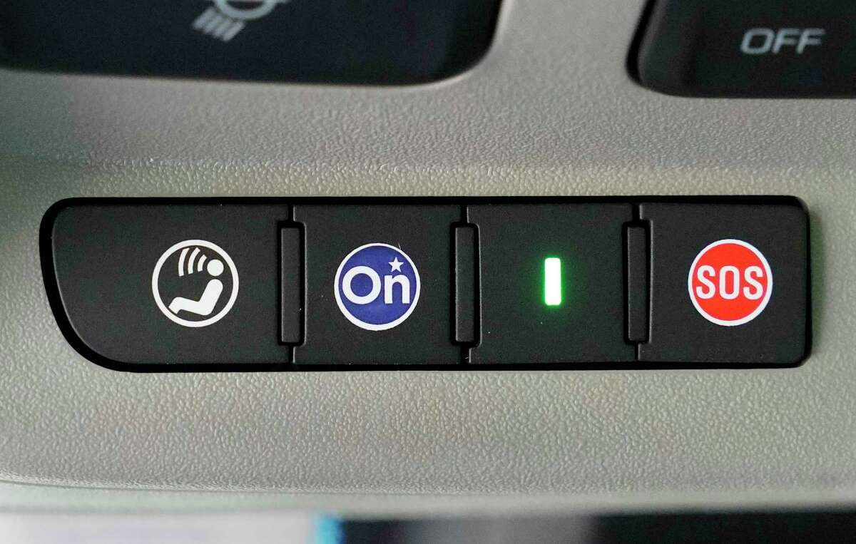 The OnStar button is shown the 2014 Cadillac.