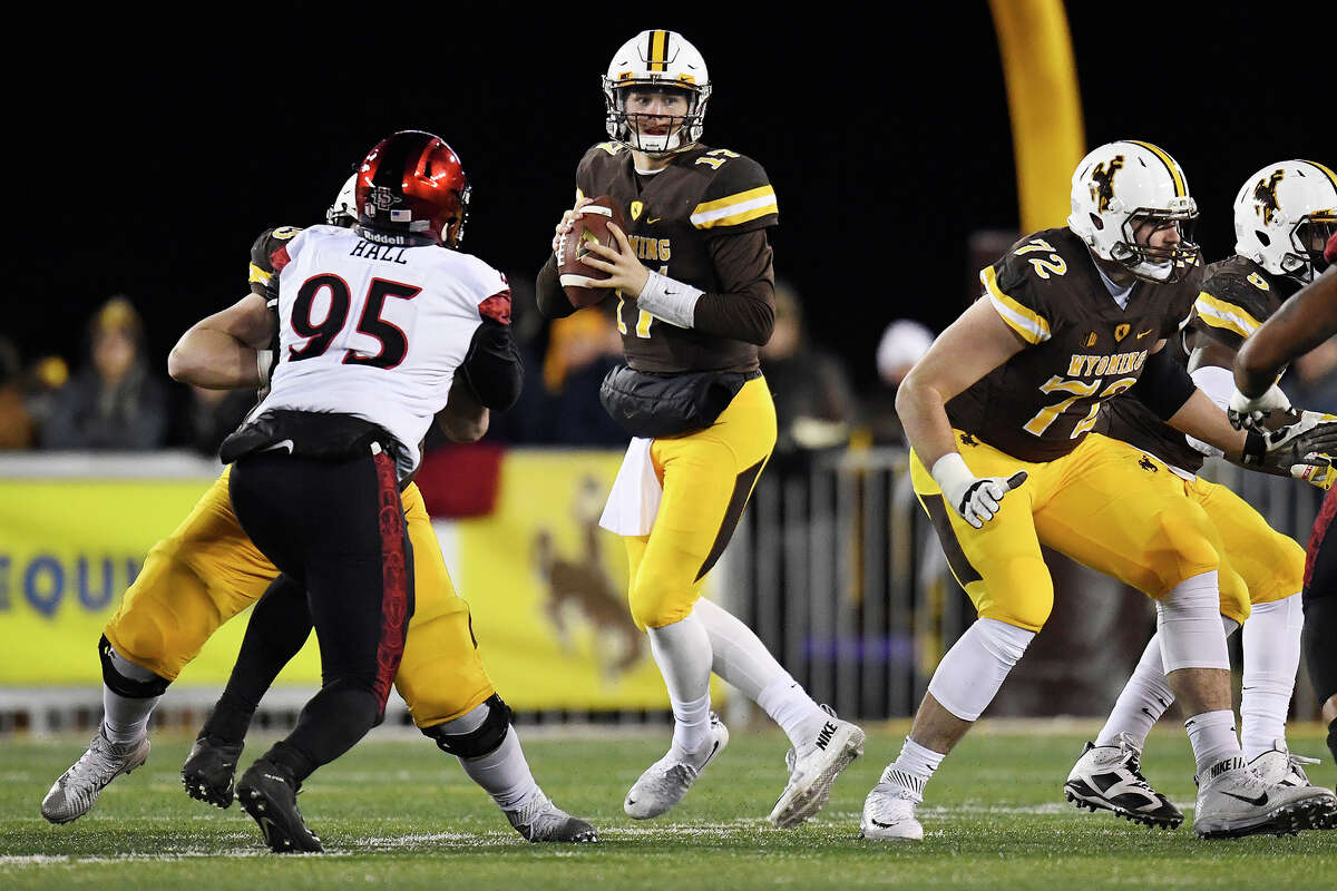 Josh Allen, playing quarterback for the Wyoming Cowboys, dropping back against the San Diego State Aztecs during the first quarter of play on Saturday, Dec. 3, 2016.
