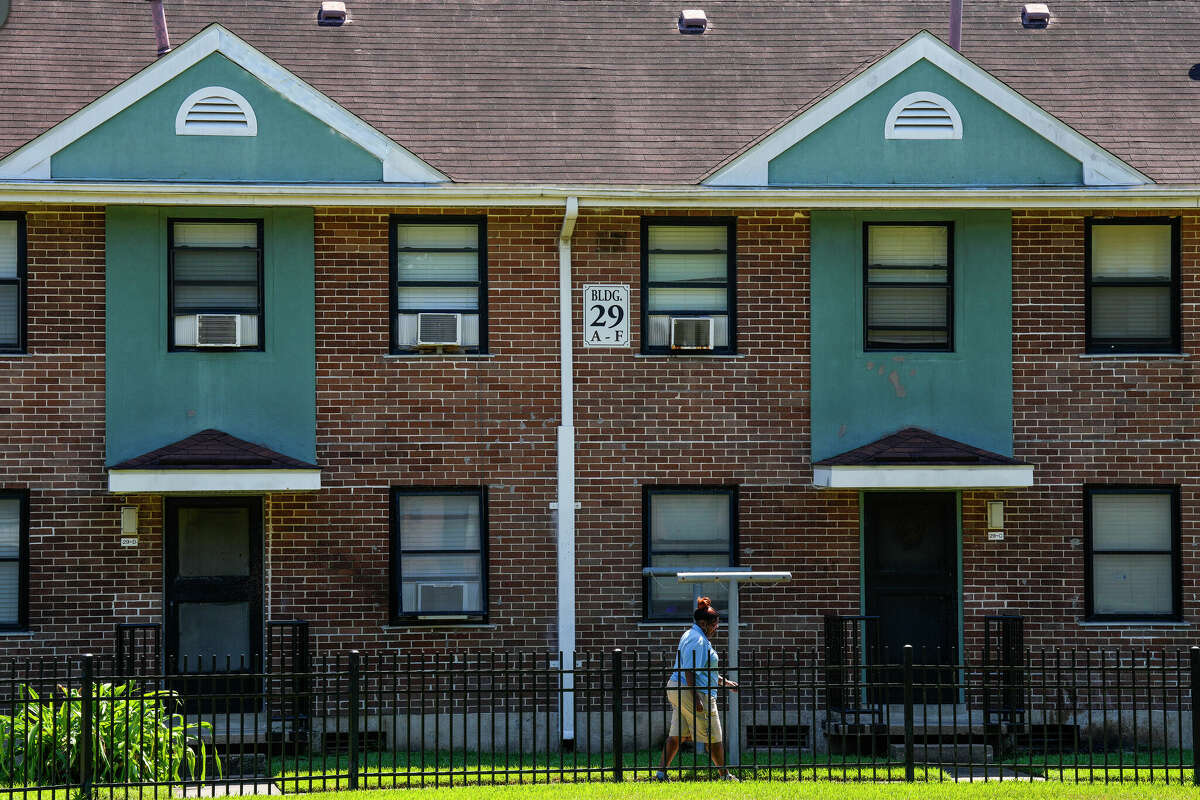 A resident walks through Cuney Homes on Wednesday, Sept. 14, 2022 in Houston. Cuney Homes is one of the 10 places available on the waitlist for applicants who need affordable housing. 