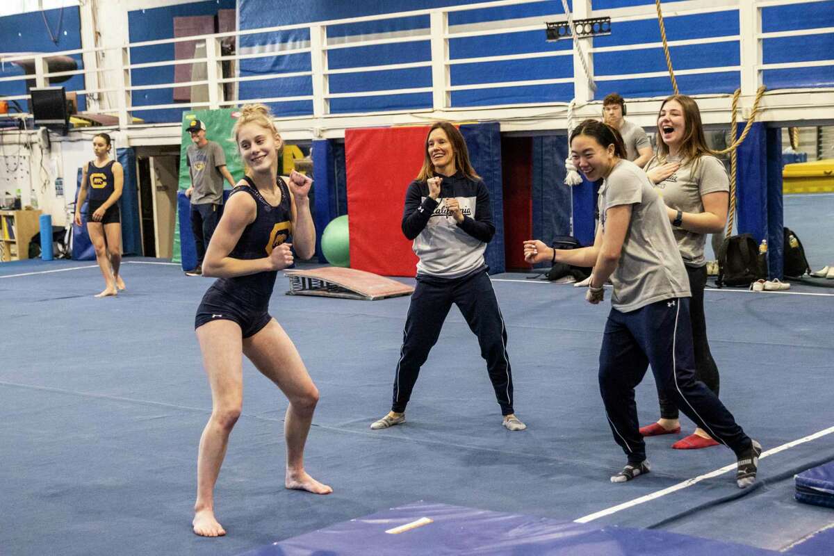 California Women's Gymnastics team co-head coach Elisabeth Crandall-Howell, center, dances with gymnasts Ella Cesario, left, and Andi Li during practice at the Golden Bear Recreation Center in Berkeley, Calif., Thursday, Jan. 12, 2023.