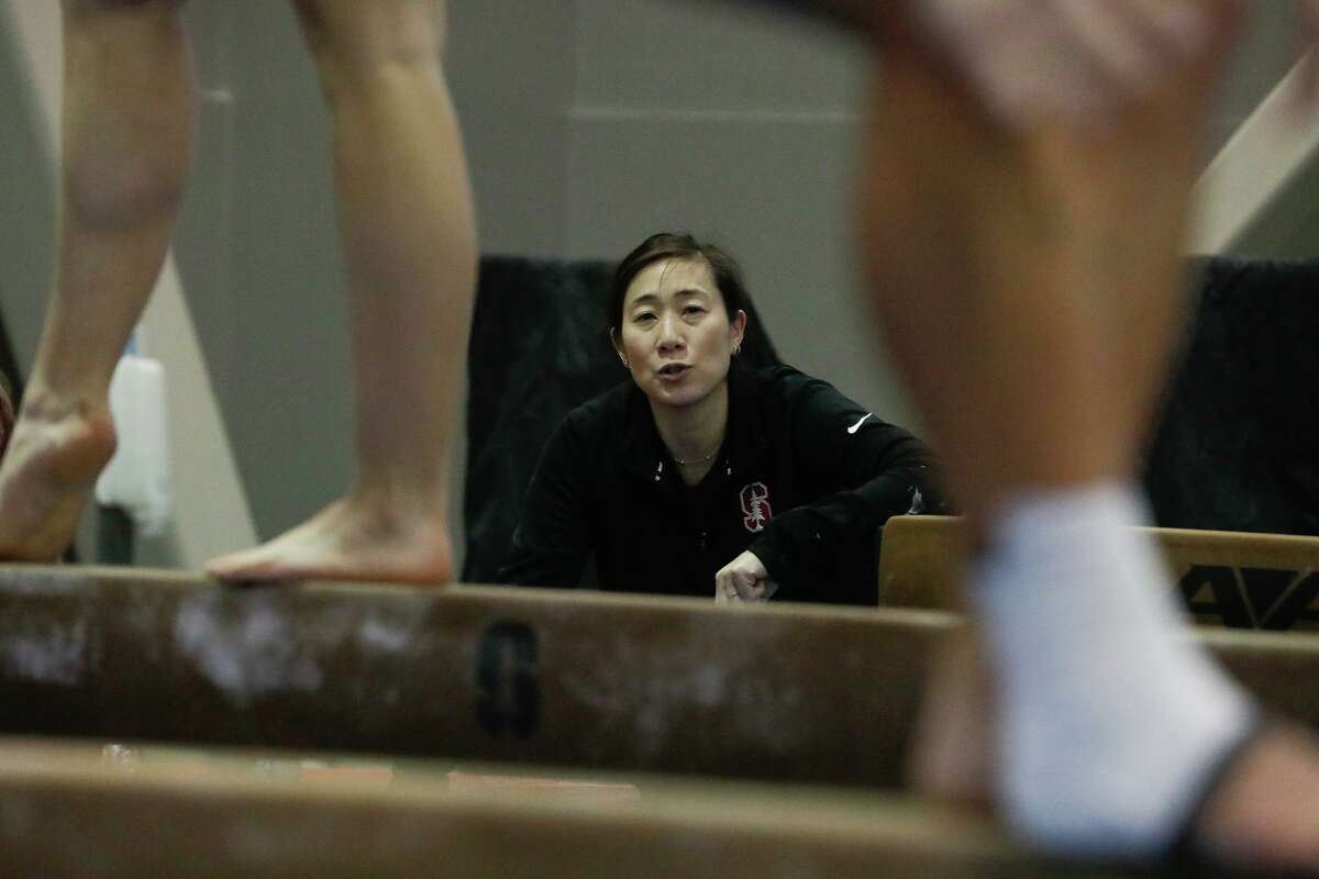 Tabitha Yim, Rodgers Family Director of Women’s Gymnastics, works with Stanford women’s gymnastics team members during practice at the Burnham Pavilion & Ford Center at Stanford University on Tuesday, January 10, 2023 in Stanford, Calif.