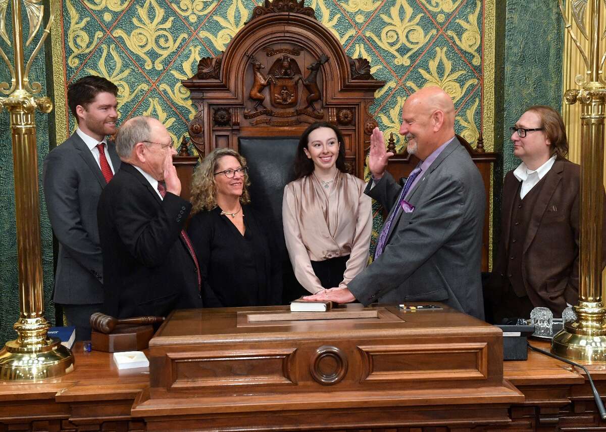 Rep. Curt VanderWall was sworn in by House Clerk Gary Randall in January 2023 for his second term in the Michigan House of Representatives.